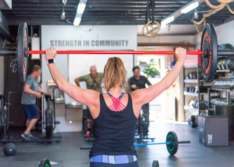 Woman lifting barbell during strength training at Sasquatch Strength in Redmond