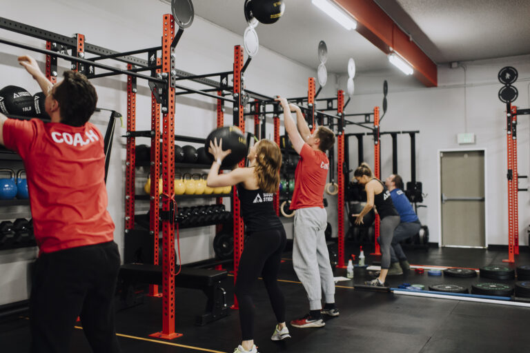 Coaches and members training together at Sasquatch Strength gym in Redmond WA