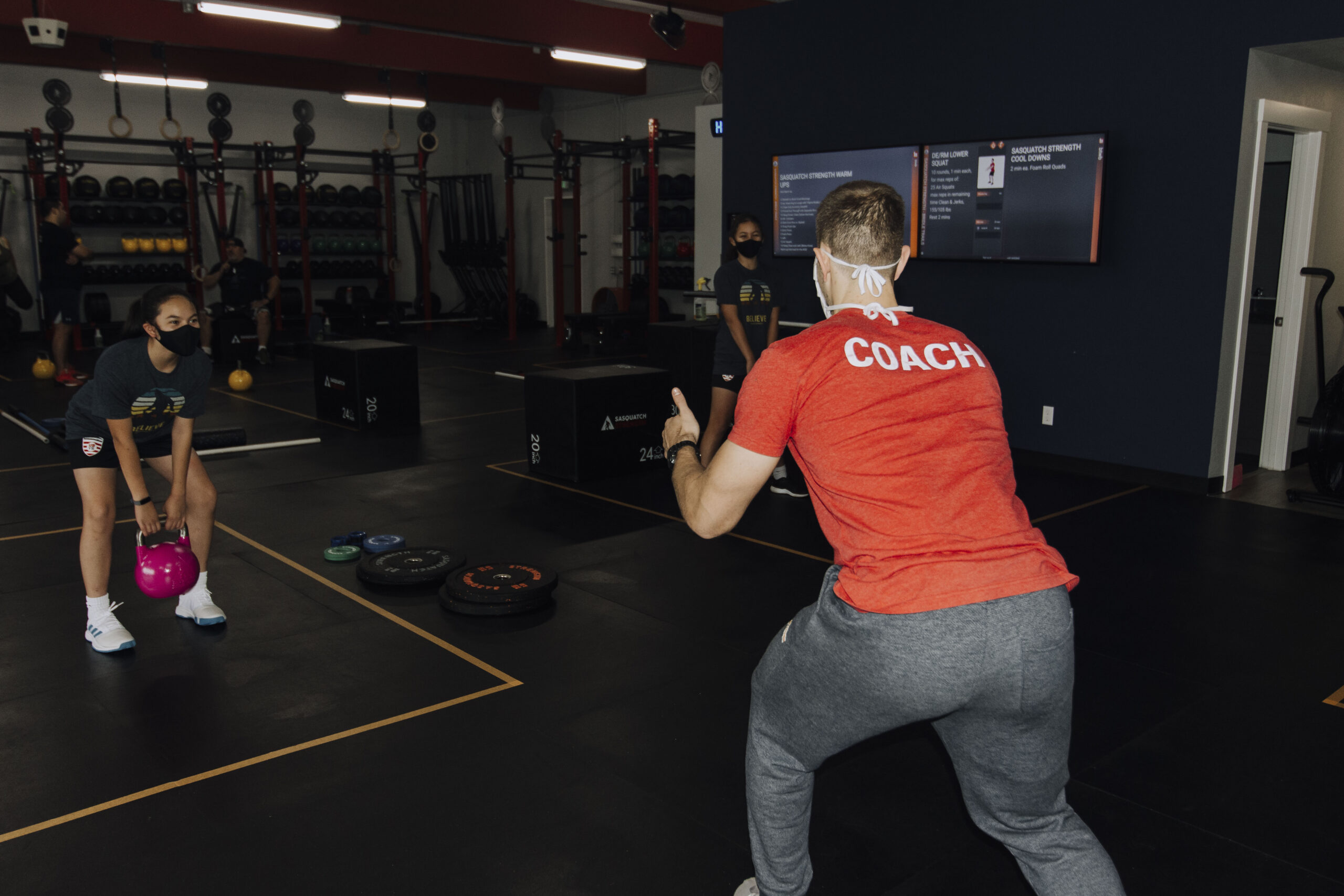 Coach instructing a group workout at Sasquatch Strength