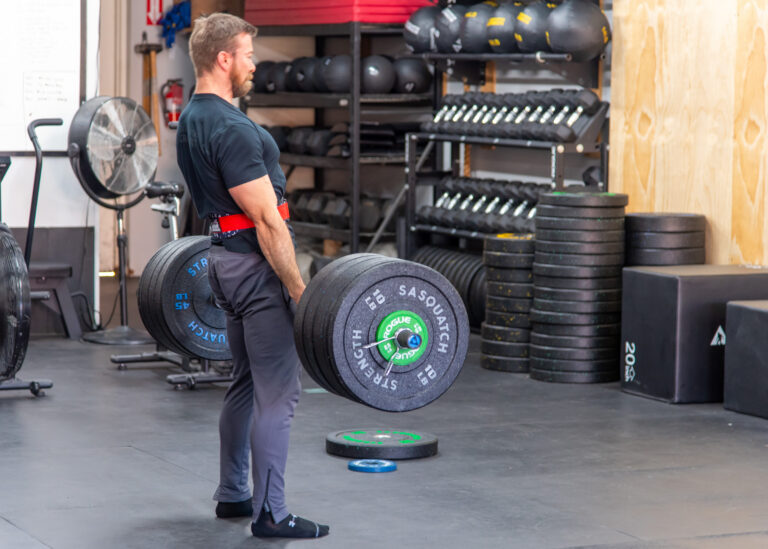 Man training with a barbell in a focused strength session